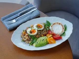 Cook quinoa in milk and top with a soft-boiled egg and avocado slices for a savory, protein-packed breakfast bowl.