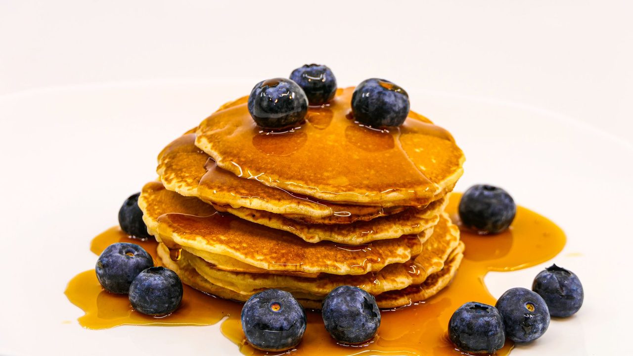 Whip up a quick batch of protein pancakes using oat flour and a scoop of your favorite powder, then top with a dollop of Greek yogurt.